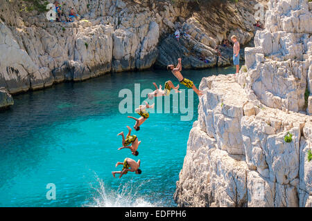 Miltiple exposure composite image of man doing a backflip from a rocky outcrop at Calanque de Sugiton Stock Photo