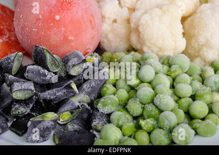heap of frozen tomato, asparagus, peas and cauliflower Stock Photo