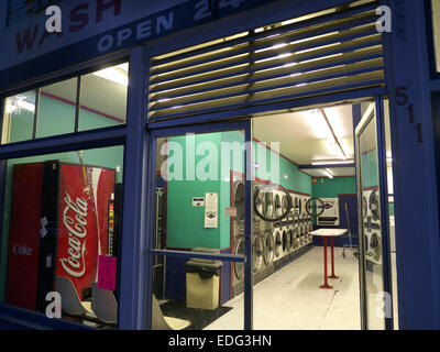 Laundromat coin wash laundry interior with washing machine door open & Coca Cola machine at night in Pacific Grove California USA  "Americana" town Stock Photo