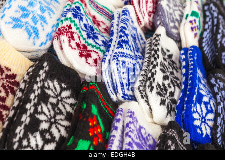 Colorful woolen mittens lie on the market counter Stock Photo