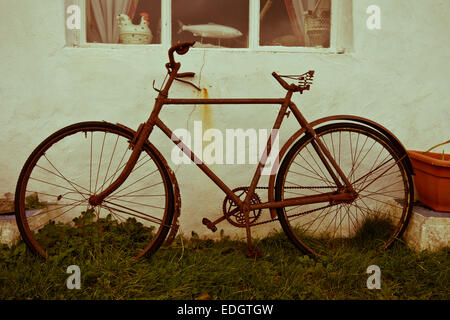 Old rusty bicycle outside the Old Point House public house, Angle headland, Pembrokeshire, Wales UK Stock Photo