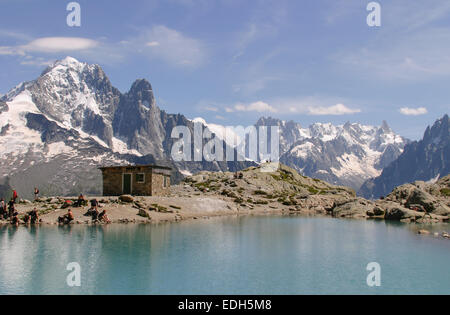 Tourists and walkers at Lac Blanc one of the most popular walks from Chamonix in the French Alps.  On Tour de Mont Blanc walk. Stock Photo
