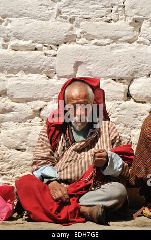 Man wearing traditional clothes in Jampey Lhakhang temple, Jakar, Bumthang, Bhutan Stock Photo