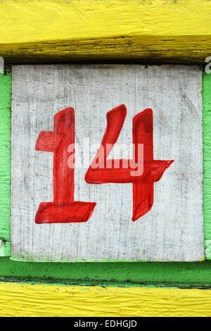 Number fourteen painted on an old painted wood board Stock Photo
