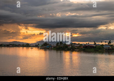Colorful sunset on the Sarawak River from the Waterfront Promenade in Kuching, Borneo, Malaysia. Stock Photo