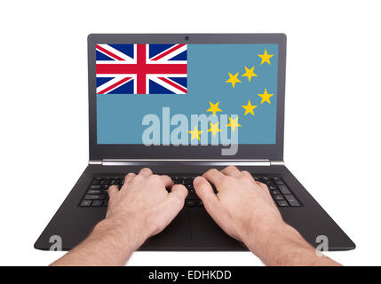 Hands working on laptop showing on the screen the flag of Tuvalu Stock Photo