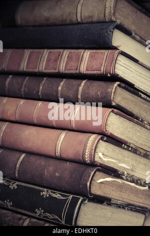 Big stack of old books with leather covers, vintage toned photo with filter effect Stock Photo