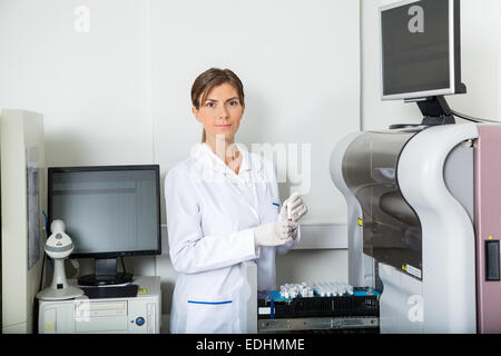 Scientist Loading Coagulation Analyzer With Samples Stock Photo