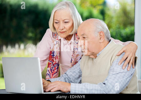 Serious Senior Man And Woman Using Laptop Stock Photo