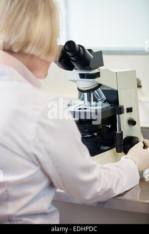 Female Researcher Using Microscope Stock Photo