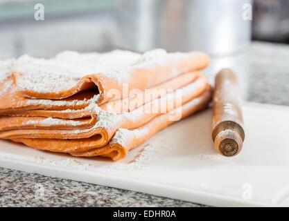 Flour On Ravioli Pasta Sheets With Rolling Pin At Countertop Stock Photo