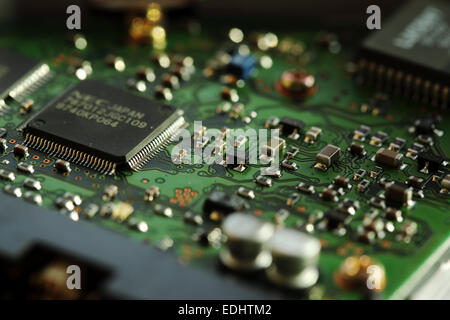 Micro-circuitry from a computer. The integrated circuit board has microchips.. Stock Photo