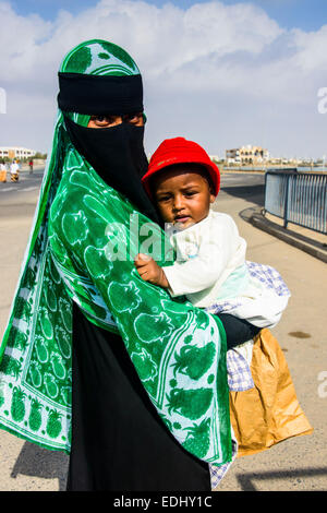 Fully veiled Muslim woman and her child, Massawa, Eritrea Stock Photo