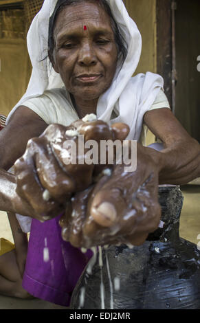 Sivasagar, Assam, India. 7th Jan, 2015. An elderly Ahom tribal woman prepares 'Saaj-Pani' (Rice Beer) using the indigenous method at her house ahead of Bhogali Bihu - The festival of feast, at a village in Sivasagar district of northeastern Assam state on January 7, 2015. Rice beer is a delicacy among all the tribal communities inhabiting northeast India and almost each and every household prepares their own rice beer for their daily consumption. © Luit Chaliha/ZUMA Wire/ZUMAPRESS.com/Alamy Live News Stock Photo