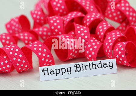 Happy birthday card with pink dotty ribbon Stock Photo