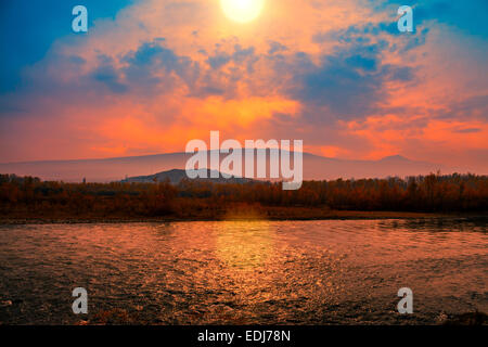 Foggy sunset over mountain river