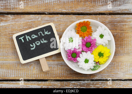 Thank you written on little blackboard with santini flowers Stock Photo