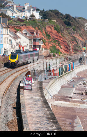 Cross Country Trains passenger train passing over the damaged section of seawall at Dawlish Stock Photo