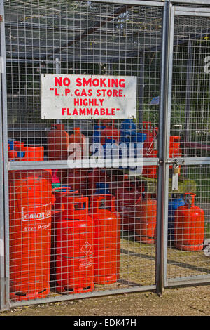 Bottles of butane and propane gas stored in security cage. Stock Photo