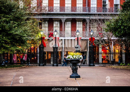 Red ribbons at the gateway into Jackson Square, looking at the shop frontages on St. Ann Street in New Orleans LA Stock Photo