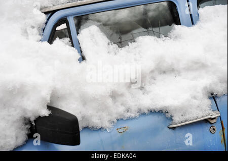 Detail shot with an abandoned old car in winter time Stock Photo