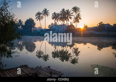 Palm trees reflected in Nam Pilu river at dawn, Loikaw Stock Photo