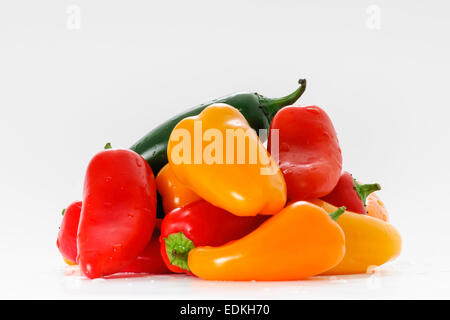 Assortment of Red, Yellow, Orange and Green Peppers on White Stock Photo
