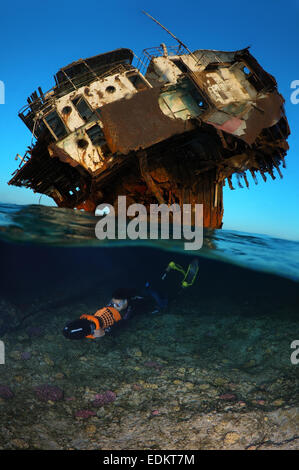 Split level, freediver swims to underwater scooter near the wreck, Red Sea, Egypt Stock Photo