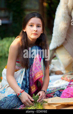 Portrait of teenage girl in a gypsy summer dresses in the garden Stock Photo