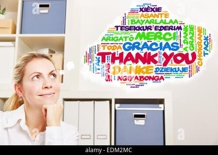 Woman in office thinking about thank you in many different languages Stock Photo