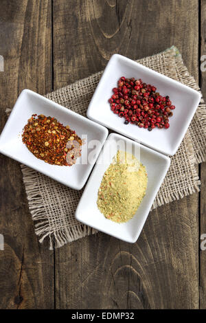 Spices in ceramic bowls on rustic wooden background Stock Photo