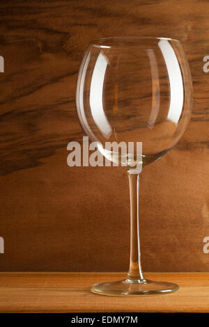 Glass of wine on the wooden background from real wood veneer with interesting growth Stock Photo