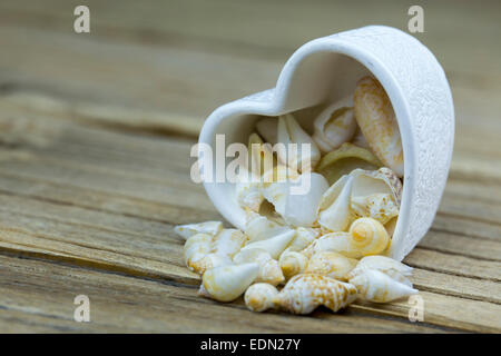 Shape of heart made with shells on a wooden table Stock Photo