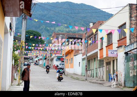 Day before Christmas lines of festive colored flags hang over the road in typical Colombian small town Fusagasuga. Stock Photo