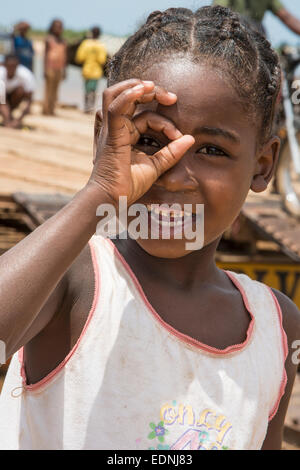 Girl, 6 years, looking through her fingers, Belo-sur-Tsirihibina, Madagascar Stock Photo