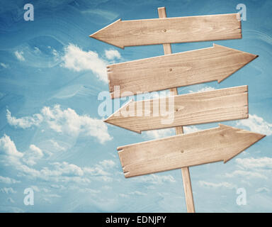 Blank brown wooden signpost against blue sky Stock Photo - Alamy