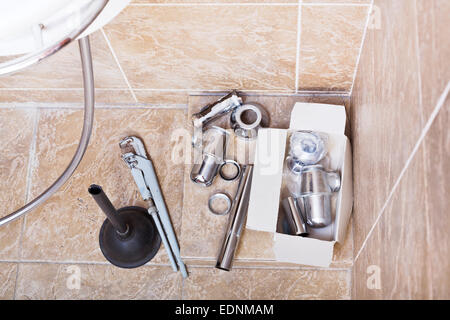 replacing of rusted plumbing trap from sink in bathroom Stock Photo