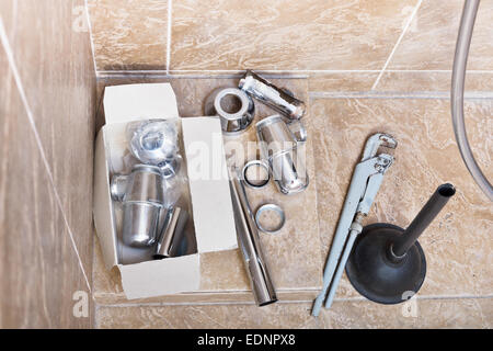 replacing of corroded plumbing trap from sink in bathroom Stock Photo
