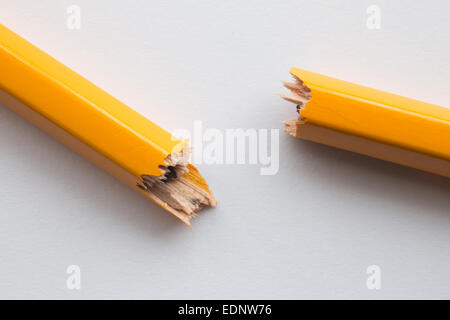Close up / macro of yellow pencil snapped or broken in two. Representative of the response relating to the Charlie Hebdo attack Stock Photo