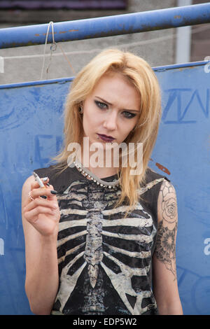 Gothic / Punk girl smoking outside. Stock Photo