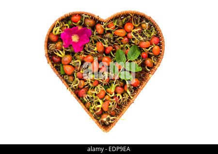 fresh summer rose hips in heart form wicker basket isolated on white Stock Photo