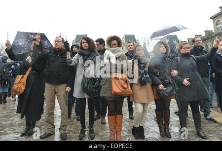 Paris, France. 8th Jan, 2015. People gather for a minute of silence for the victims of the January 7 attack against French magazine Charlie Hebdo, in Paris, France, on Jan. 8, 2015. Credit:  Li Genxing/Xinhua/Alamy Live News Stock Photo