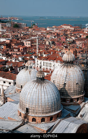 Domes of Basilica di San Marco St Marks Cathedral seen from top of St Marks Bell Tower Venice Italy with sea beyond DOMES BASILI Stock Photo