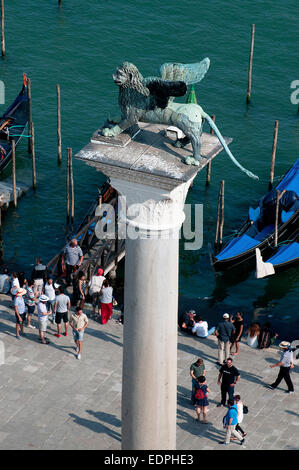 Bronze statue of winged Lion symbolising St Mark the Evangelist on column in piazzetta Venice Italy which dates from 300 bc Stock Photo