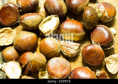 Ripe chestnuts harvest on a wooden background Stock Photo
