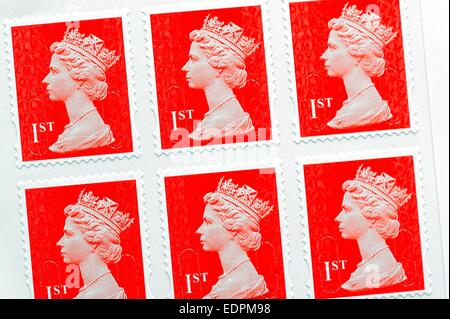 Red British first class royal mail postage stamps Stock Photo