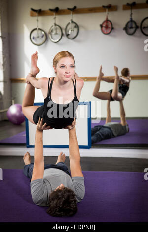 Young couple practicing acro yoga Stock Photo