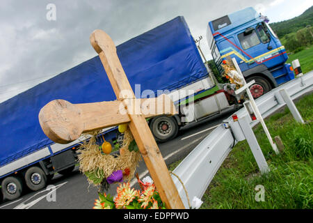 Wooden memorial cross for a traffic victims European roadside, lorry road Stock Photo