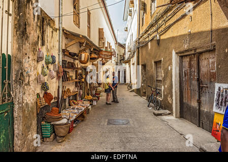 Tourists on a typical narrow street in Stone Town, Zanzibar Stock Photo