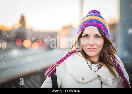 Brunette smiling under the blizzard of russian weather Stock Photo